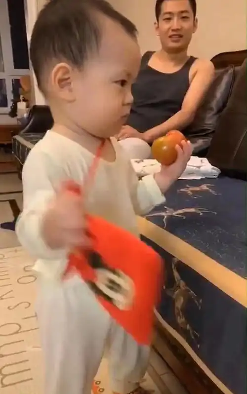  春节将至,妈妈在宝宝小挎包上张贴收款二维码,宝宝今年过年不收礼
